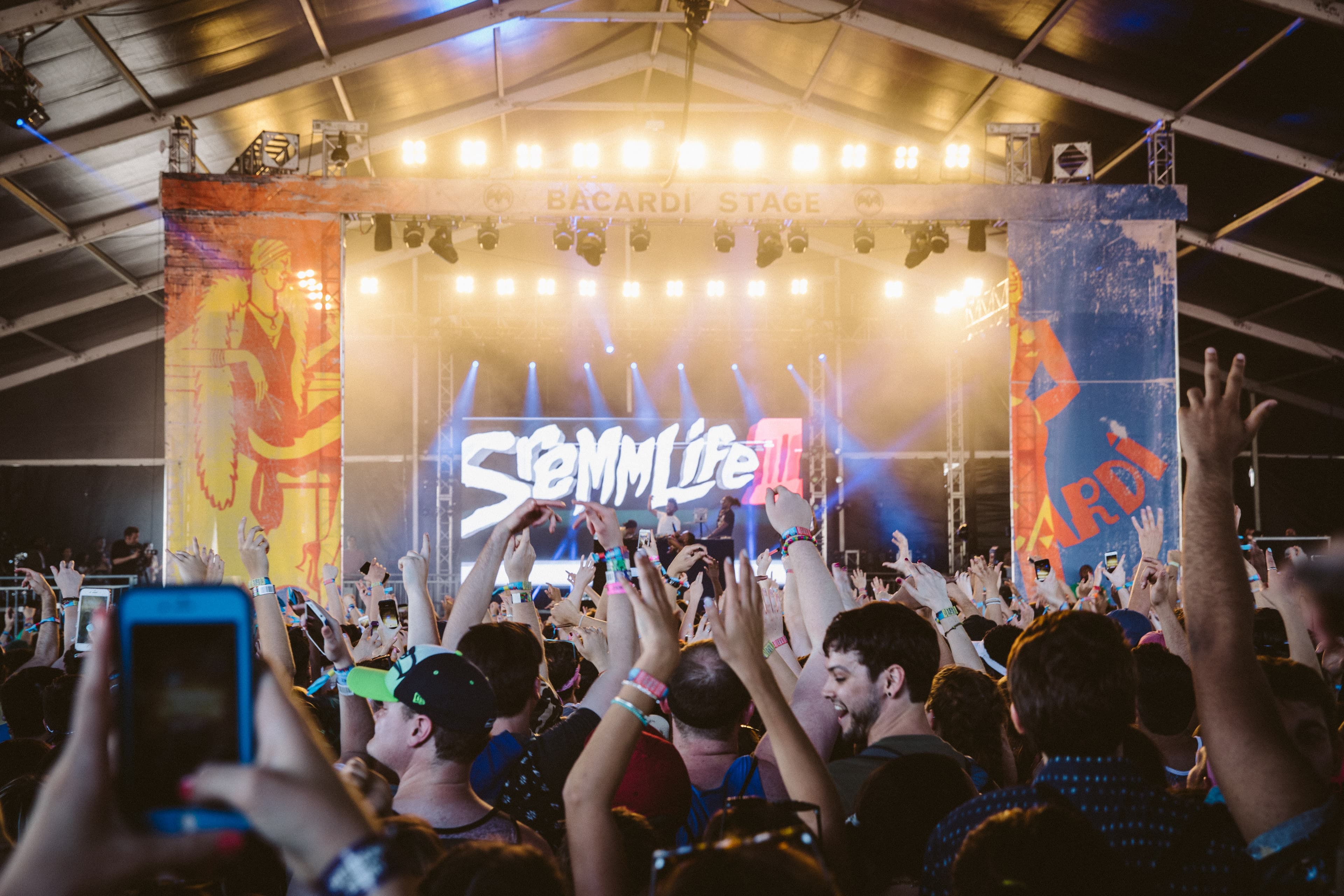 The Bacardi Stage at Governors Ball — branded stage wraps and the crowd with hands raised during a Rae Sremmurd set