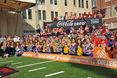 Coca-Cola Zero branding across the ESPN College GameDay set, with cheerleaders and the crowd behind the stage